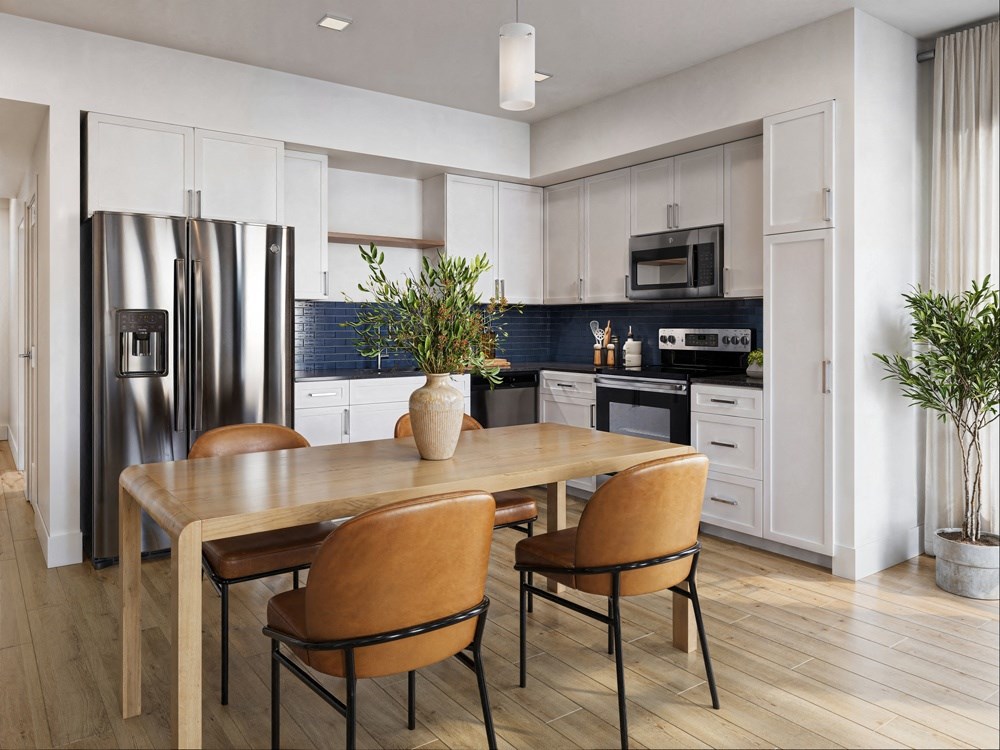 a kitchen with stainless steel appliances and a wooden table