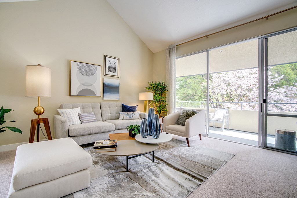 Living area with sliding glass doors to patio at Americana Apartments, Mountain View, CA
