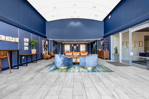 furnished lobby with high ceiling and blue wall at Aqua Via Apartment, California
