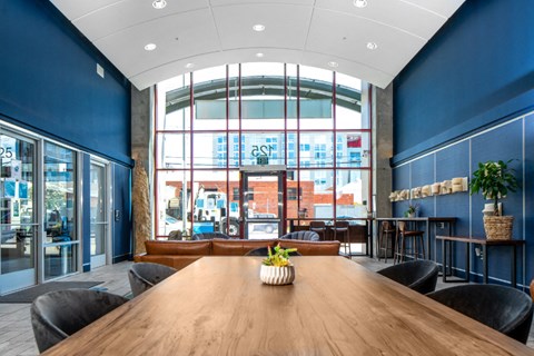 entryway lobby with long table and lounge seating at Aqua Via Apartments, California, 94607