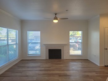 Apartments in Phoenix for Rent-Arboretum-Wood Burning Fireplace near Large Windows, Wood Style Flooring, and Ceiling Fan - Photo Gallery 12