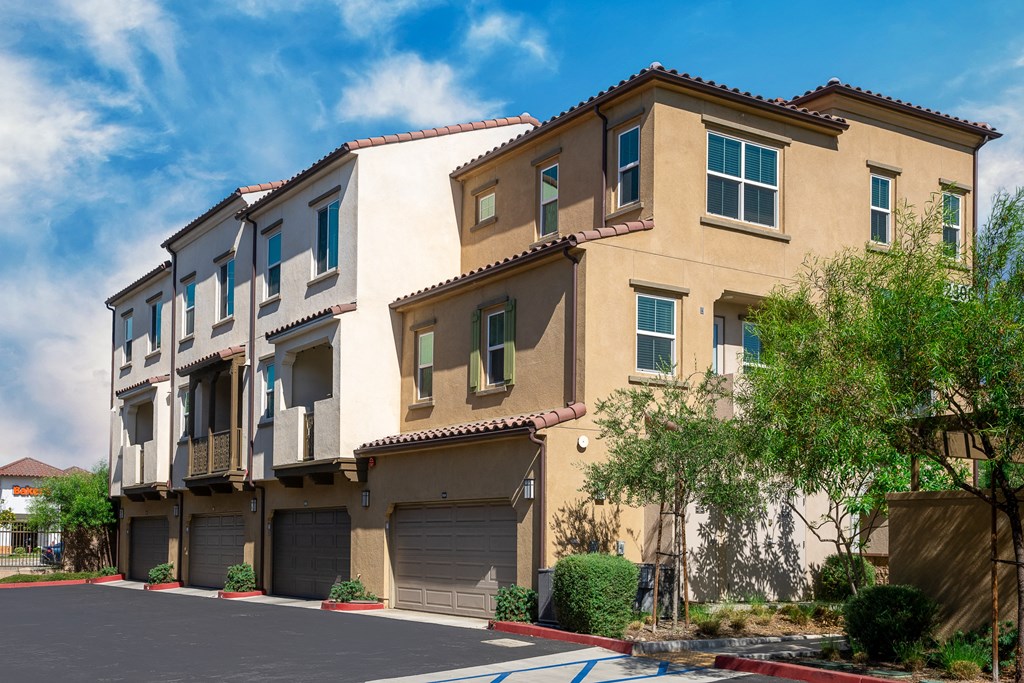 a group of apartment buildings with garages