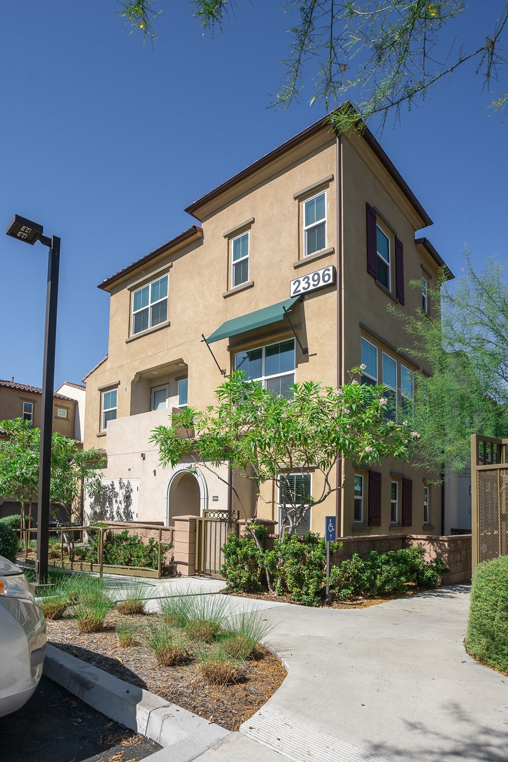 Apartment complex with sidewalks and vegetation