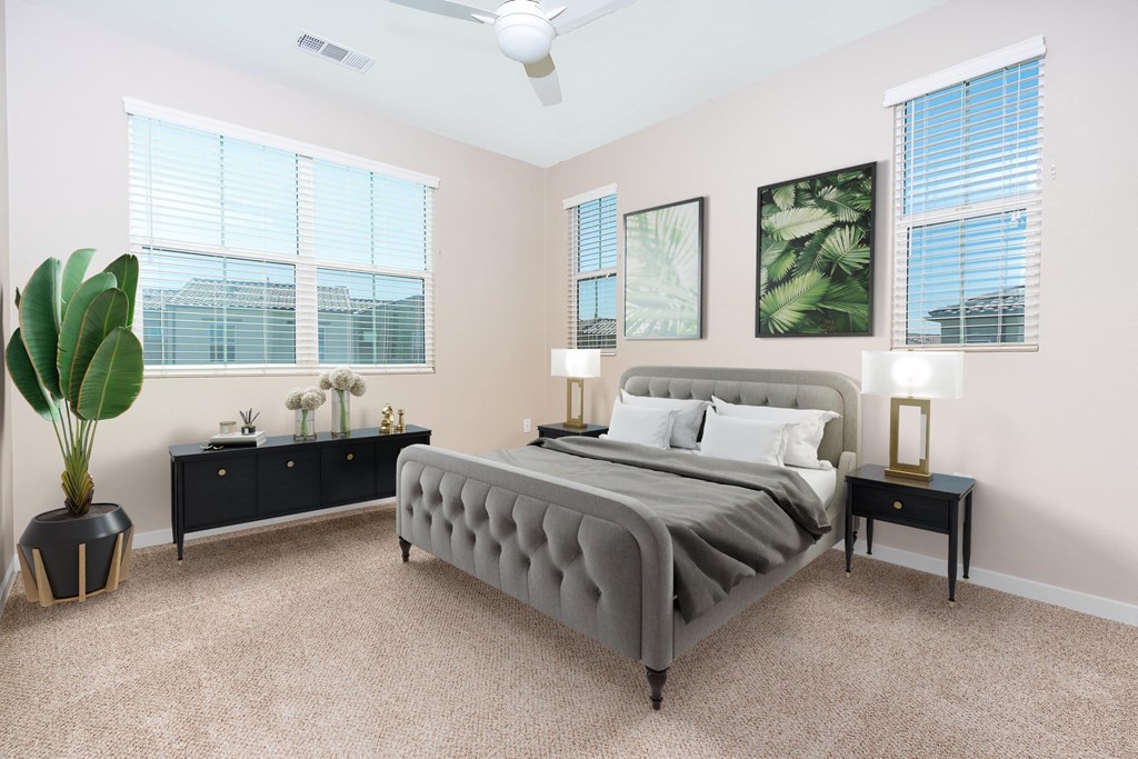 a bedroom with a bed and three windows