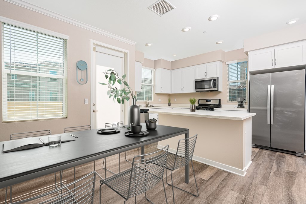 a kitchen with a large island and stainless steel appliances