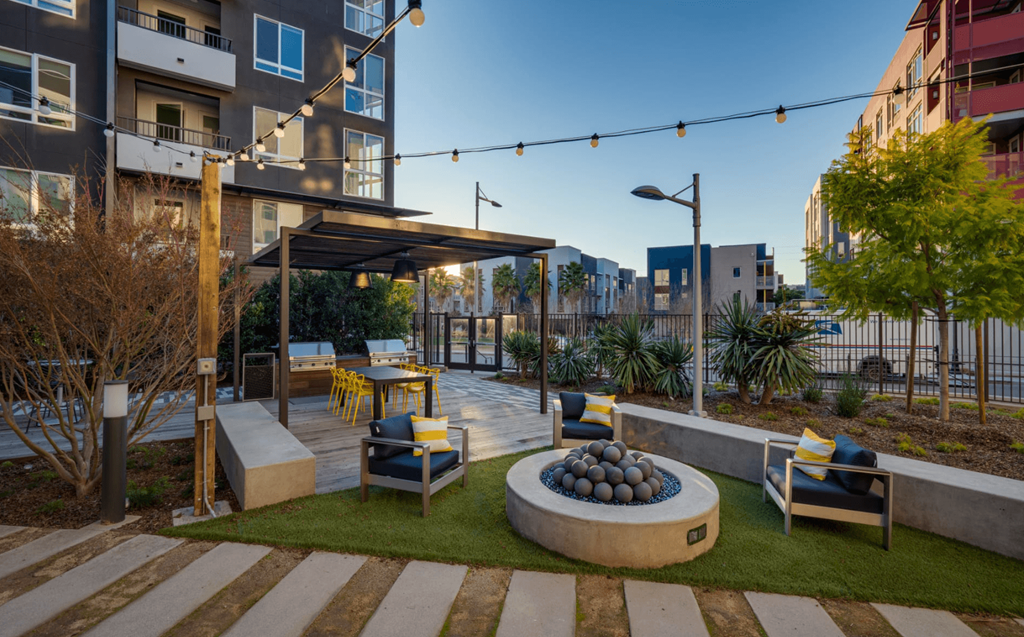 an outdoor patio with chairs and a fire pit