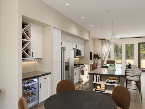 A modern kitchen with a dining table and chairs.