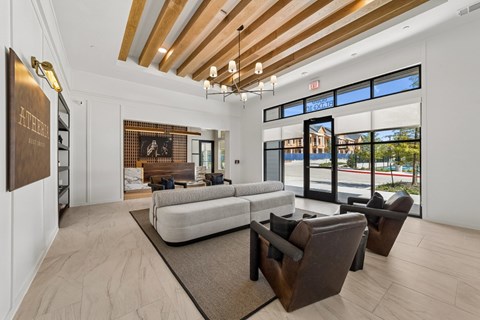 A modern living room with a white sofa and brown chairs.