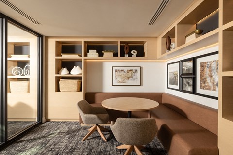 A modern dining area with a round table and chairs.
