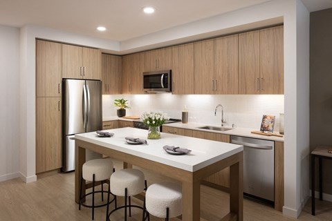 A modern kitchen with a table and chairs.