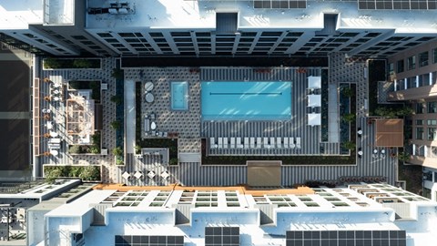 A modern building with a pool and a glass wall.