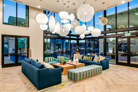 A modern living room with a blue sofa and a wooden floor.