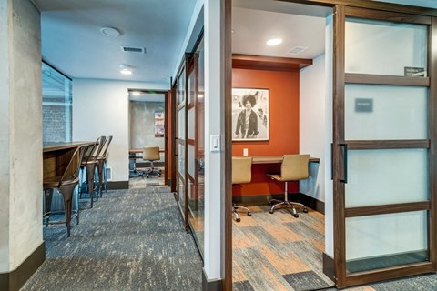 a conference room with a table and chairs and glass doors