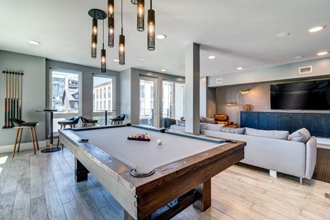a pool table in a living room with a tv