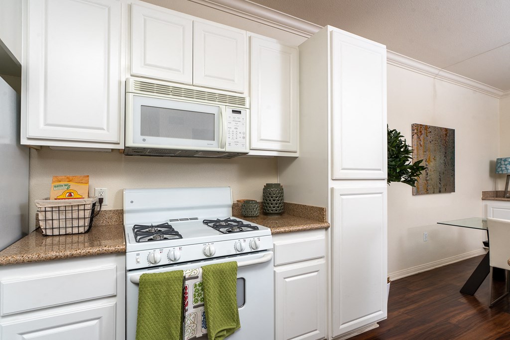 Kitchen With White Appliances, and Modern Wood Cabinets Kitchen With White Appliances, and Modern Wood Cabinets at Barrington Place, Rancho Cucamonga, 91739