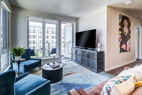 a living room with a couch and a tv and a window
