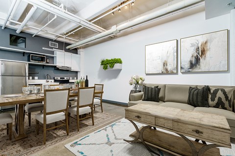 A modern kitchen with a dining table and chairs.