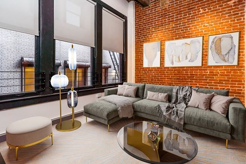 A living room with a green couch and a coffee table.