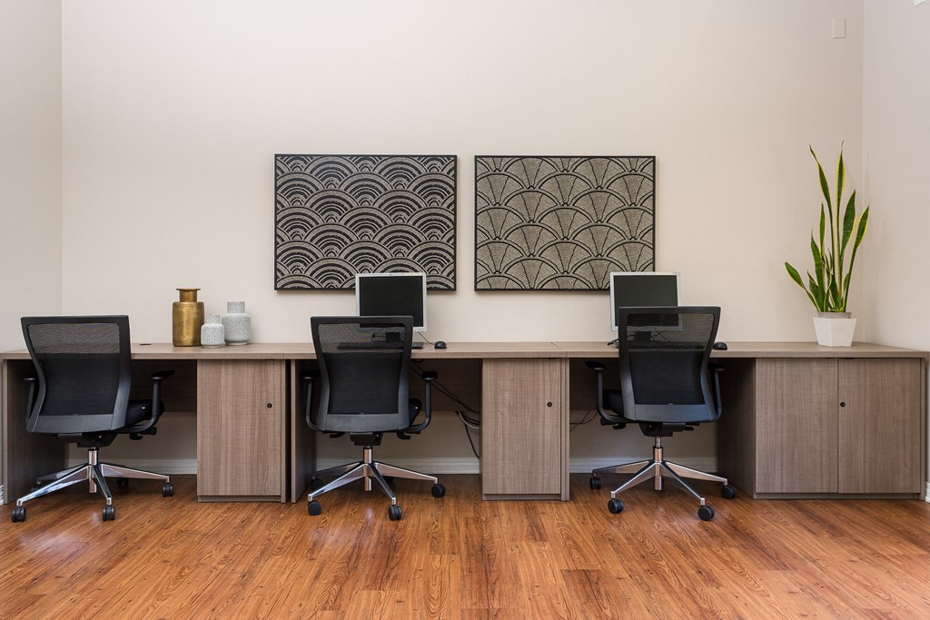 two paintings hanging on the wall of the business center at 55+ FountainGlen Temecula, California