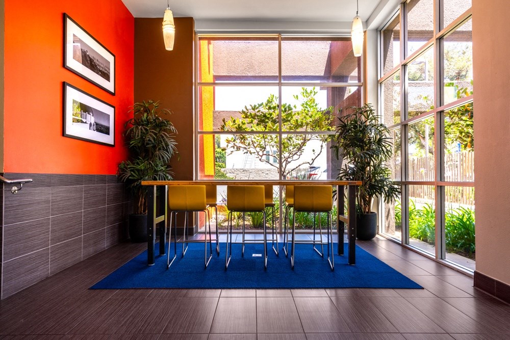 a dining room with a table and chairs in front of a window