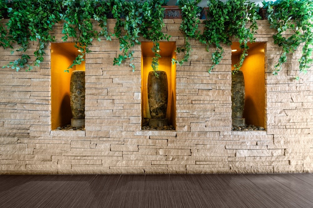 three windows in a brick wall with ivy on top of it