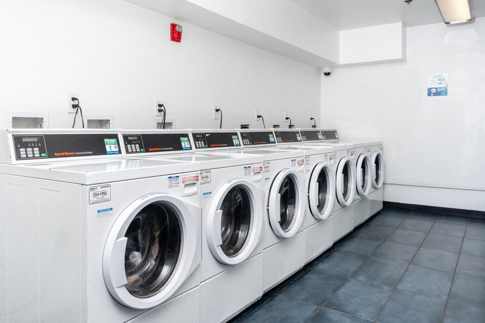 a row of washing machines in a laundry room