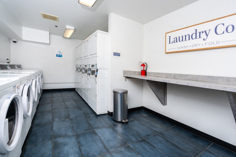 a laundry room with a washing machine and a counter