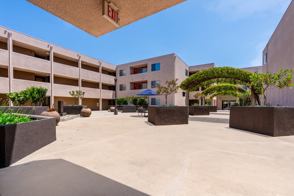 a courtyard in front of a building of a hotel