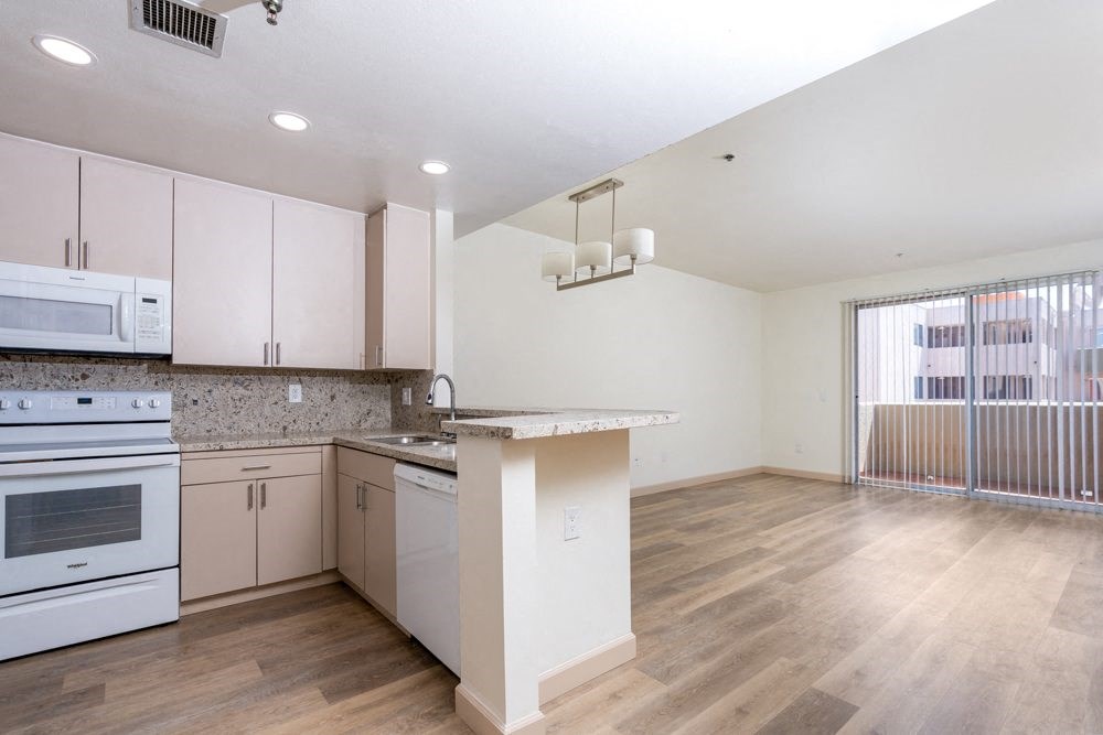 a kitchen with an island and a stove and a microwave