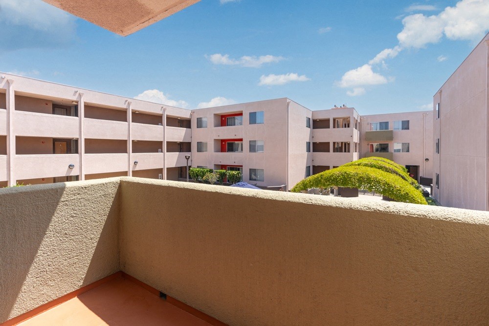a balcony with a view of an apartment building