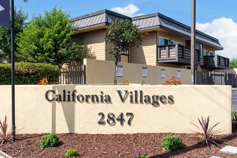 A sign for California Villages 2847 in front of a building.