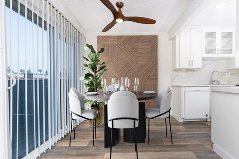 a dining room with a table and chairs and a ceiling fan