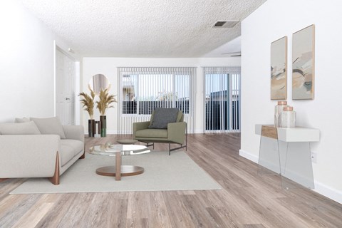 A living room with a white couch, a green chair, and a coffee table.
