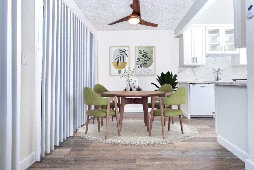A dining room with a table and chairs.