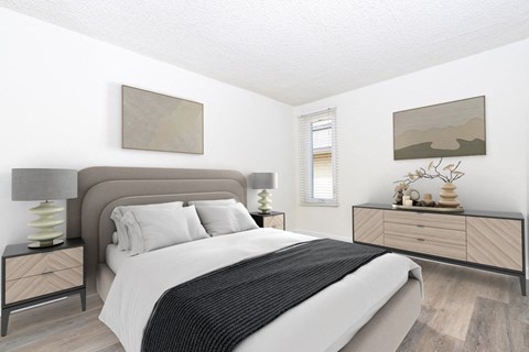 a bedroom with a bed and a dresser and a window