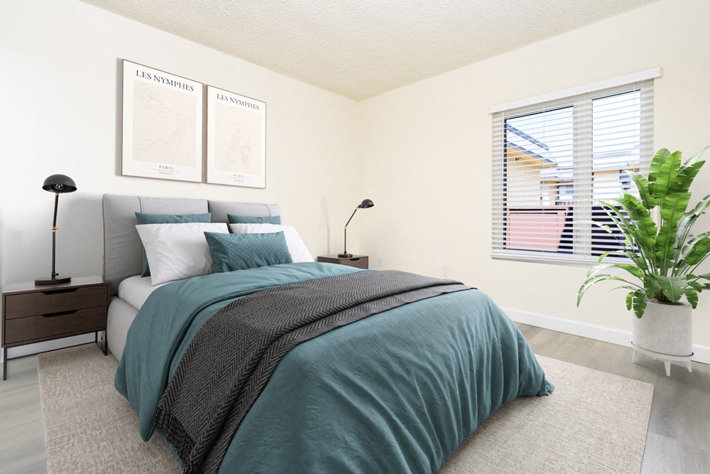 a bedroom with two windows and a bed with green sheets