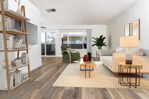 the living room of an apartment with a couch and a chair