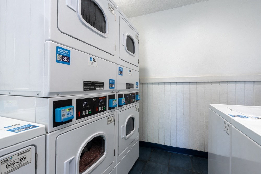 a washer and dryer in a laundry room with white walls