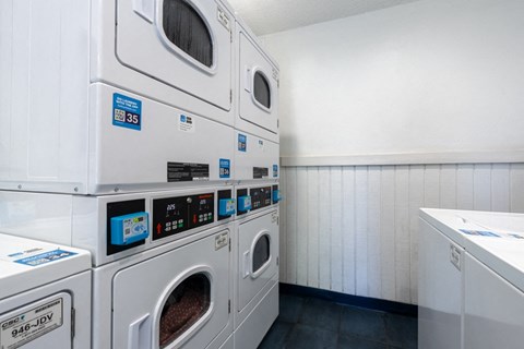 a washer and dryer in a laundry room with white walls
