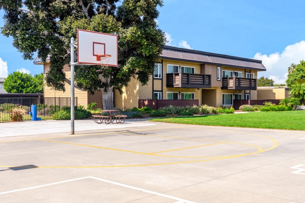 A basketball court is located in front of a building.