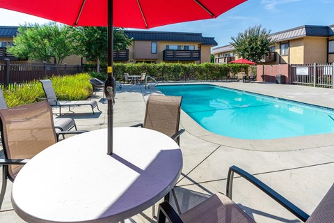 resident pool with lounge seating and umbrellas