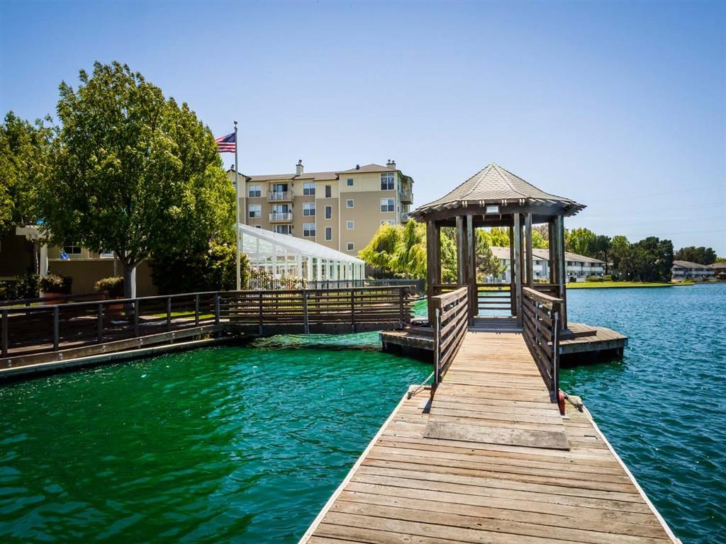 a dock with a gazebo on the water at a resort