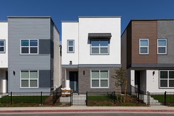 A row of modern townhouses with different colored exteriors.