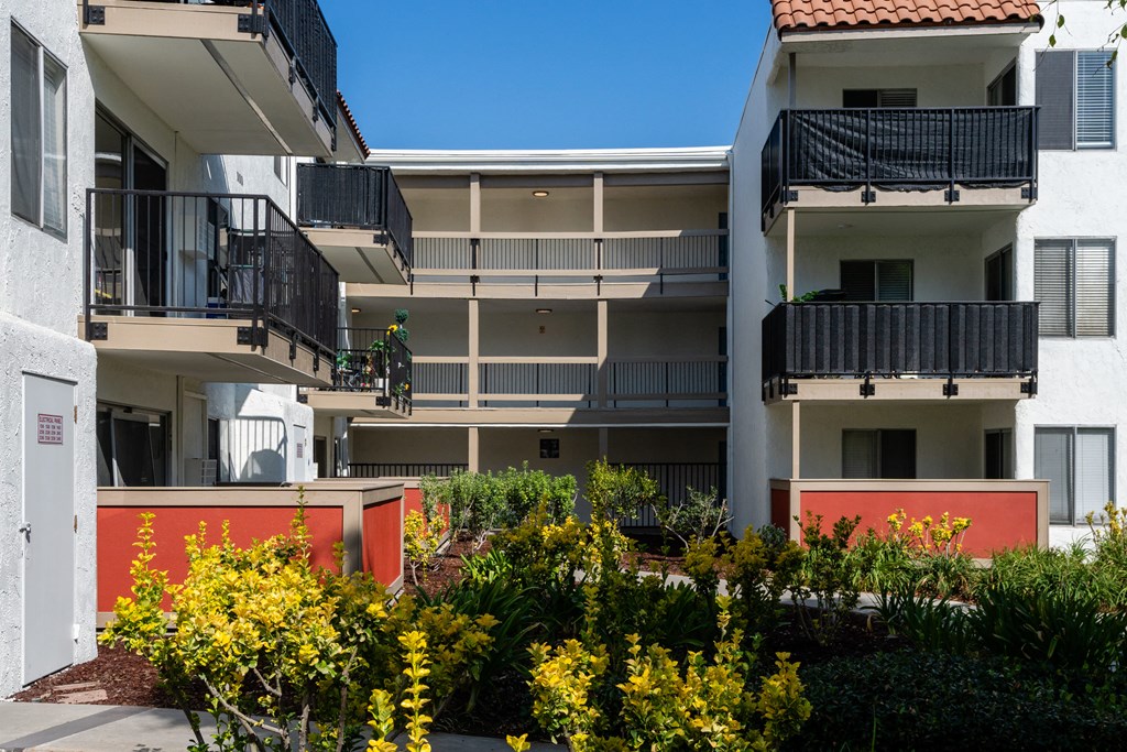 an image of an apartment building with balconies and flowers