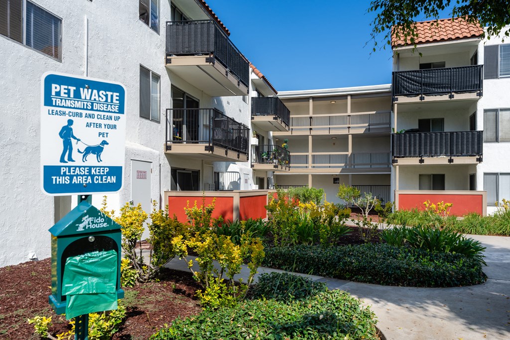 an image of an apartment building with a sign for a pet waste facility