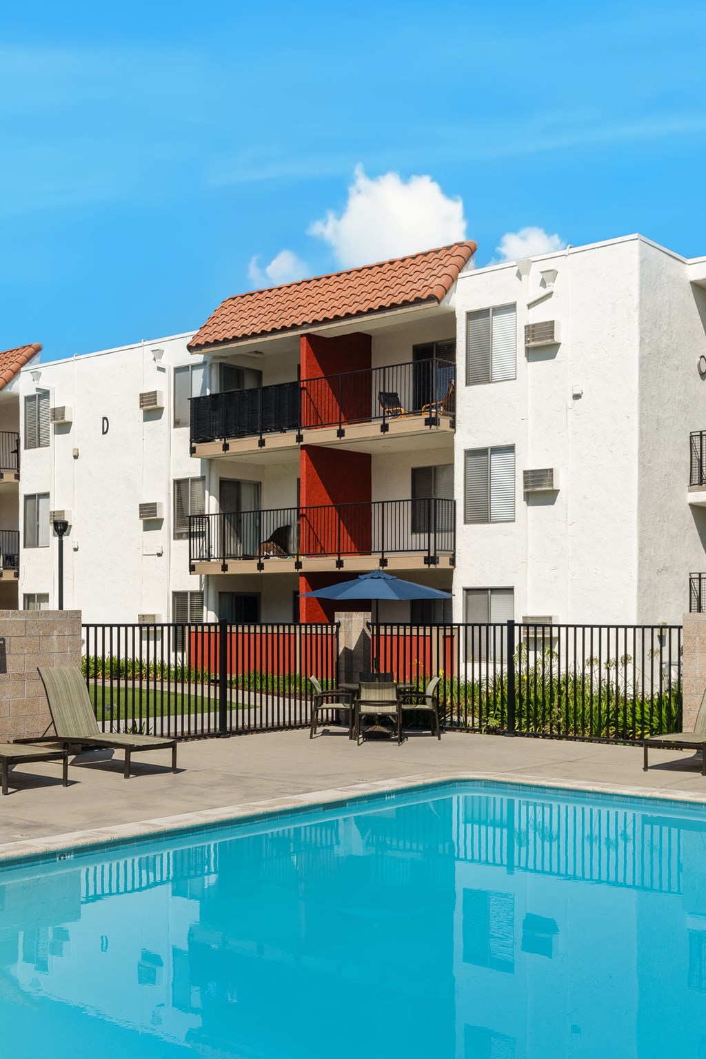 a building with a swimming pool in front of it