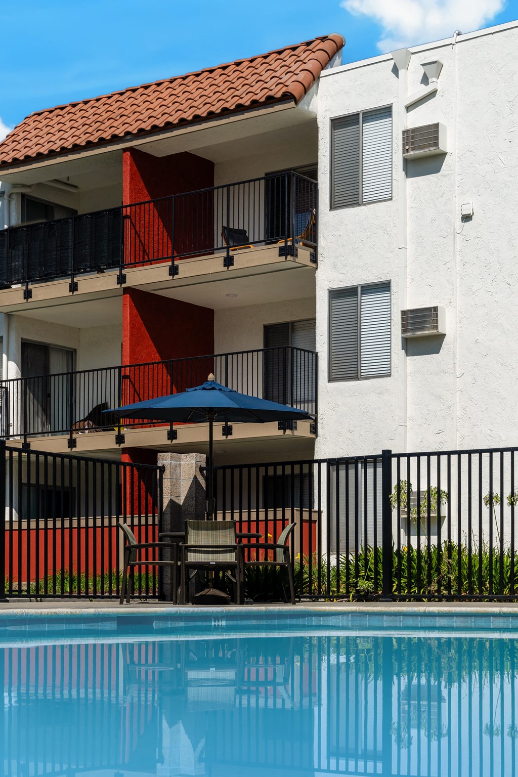 a building with a swimming pool in front of it