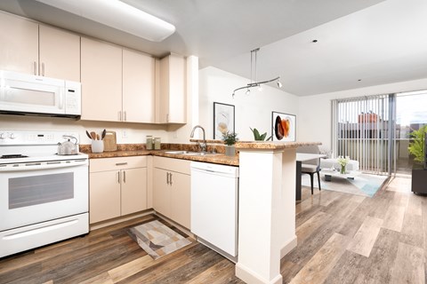 a large kitchen with white appliances and a counter top