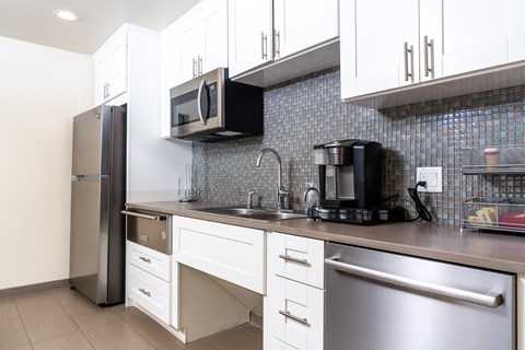 a kitchen with a sink and a refrigerator