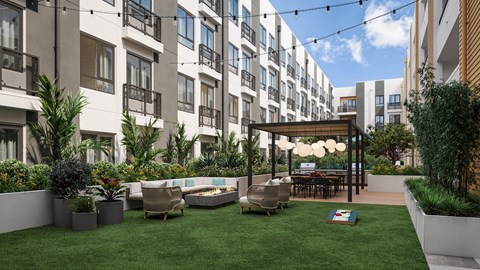A patio area with a table and chairs is surrounded by apartment buildings.